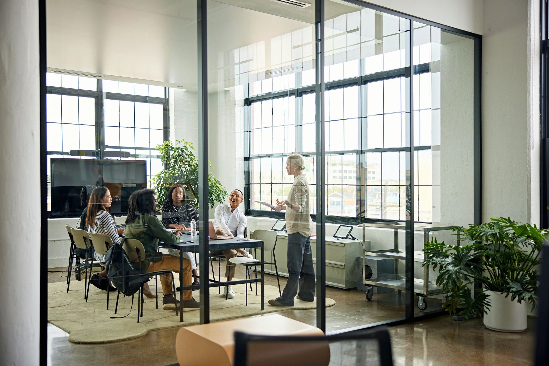Smiling colleagues meeting in a modern conference room